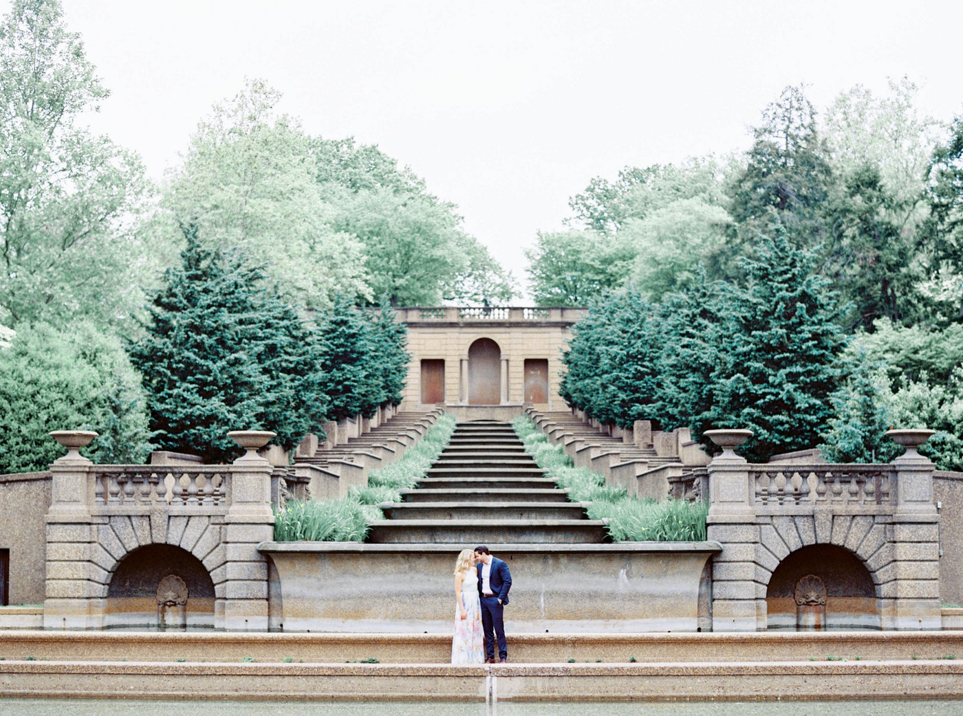 A portrait of a couple in Meridian Hill Park in Washington DC with stairs and a water feature