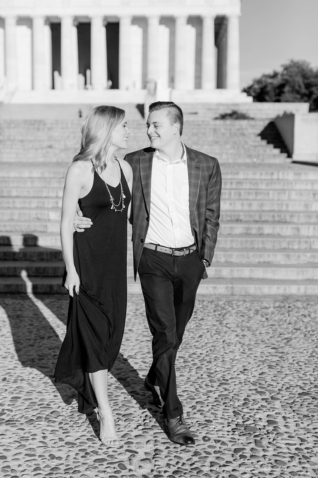 couple strolls together during engagement photos at the Lincoln Memorial in Washington DC
