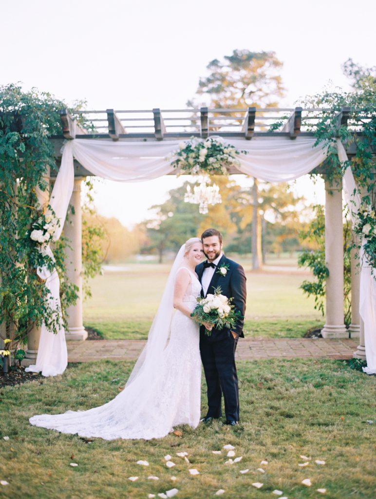 Bride and Groom portrait with ivory flowers from Wiliamsburg Florist at the Williamsburg Inn