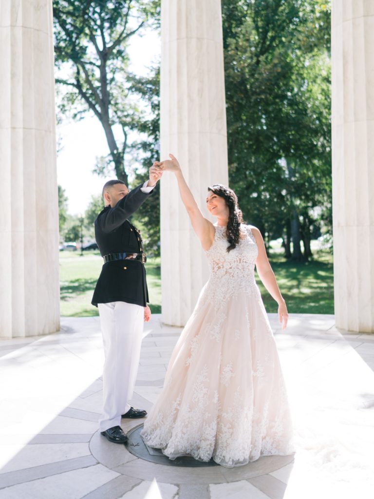 bride and groom twirling in the war memorial