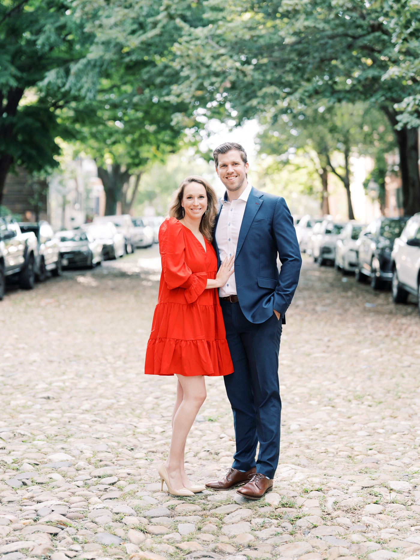 Couple in suit and dress on cobblestone street