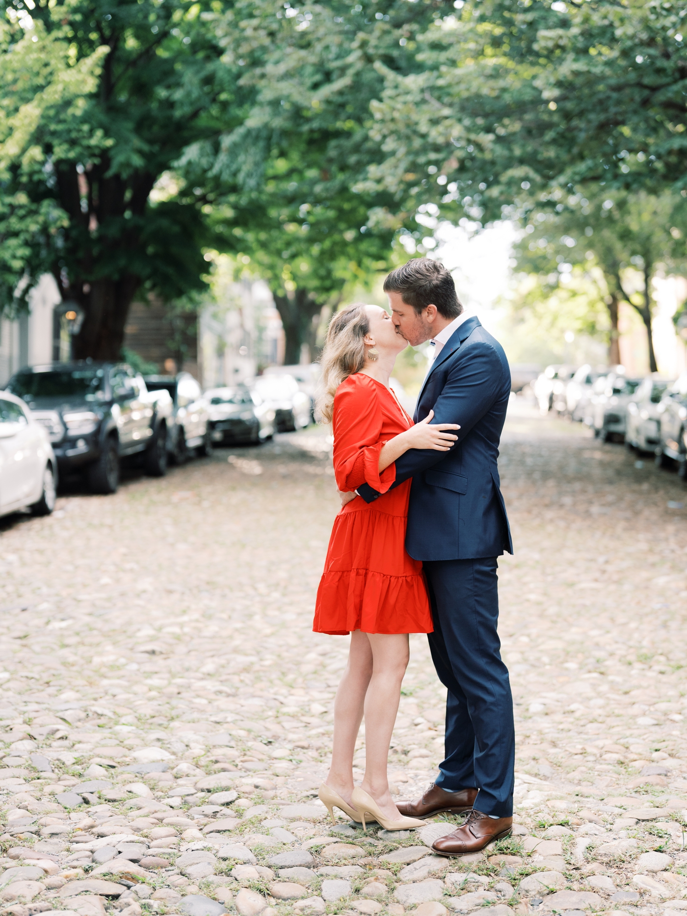 Couple in suit and dress on cobblestone street