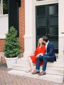 Couple in suit and dress sitting on porch in old town alexandria