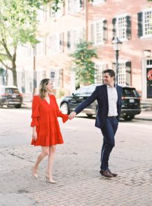 Couple in suit and dress walking in old town alexandria