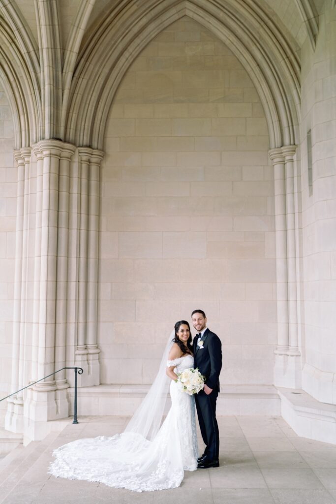 Bride and Groom smiling at the national cathedral in washington dc