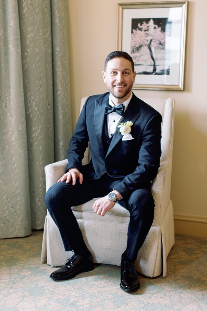 groom smiling seated portrait at the salamander hotel in washington dc