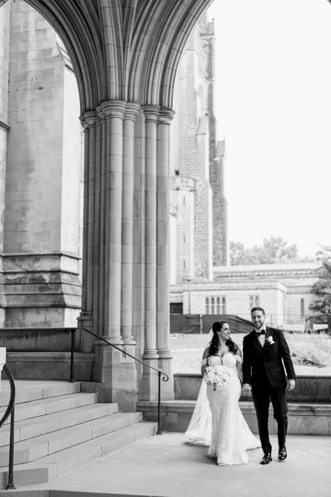 bride and groom walking at the national cathedral in washington dc