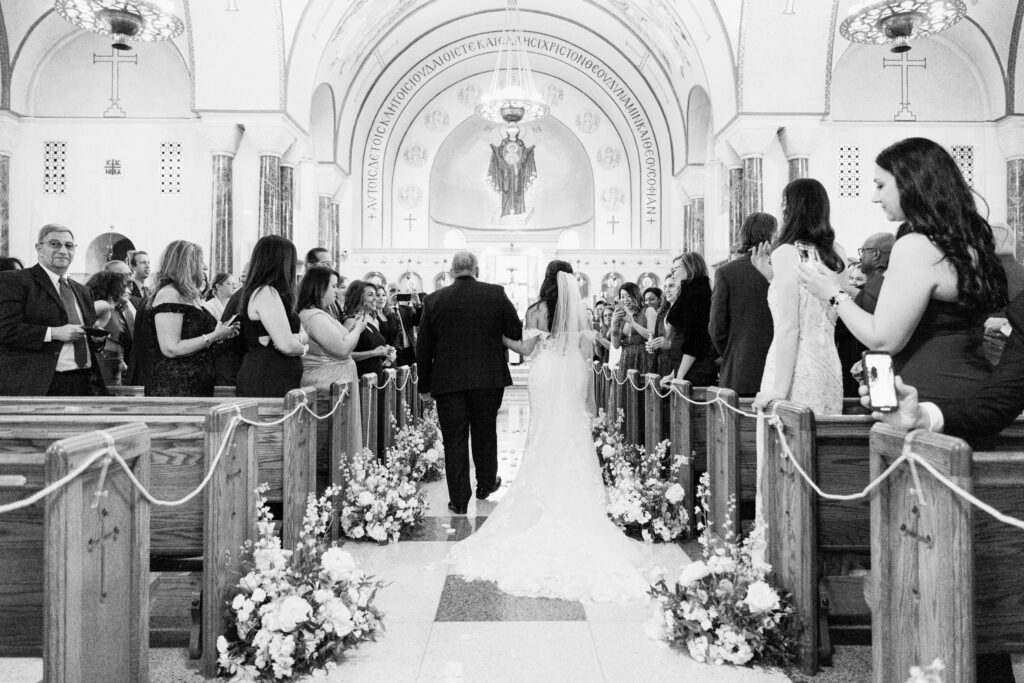 bride walks down the aisle at st sophias church in washington dc