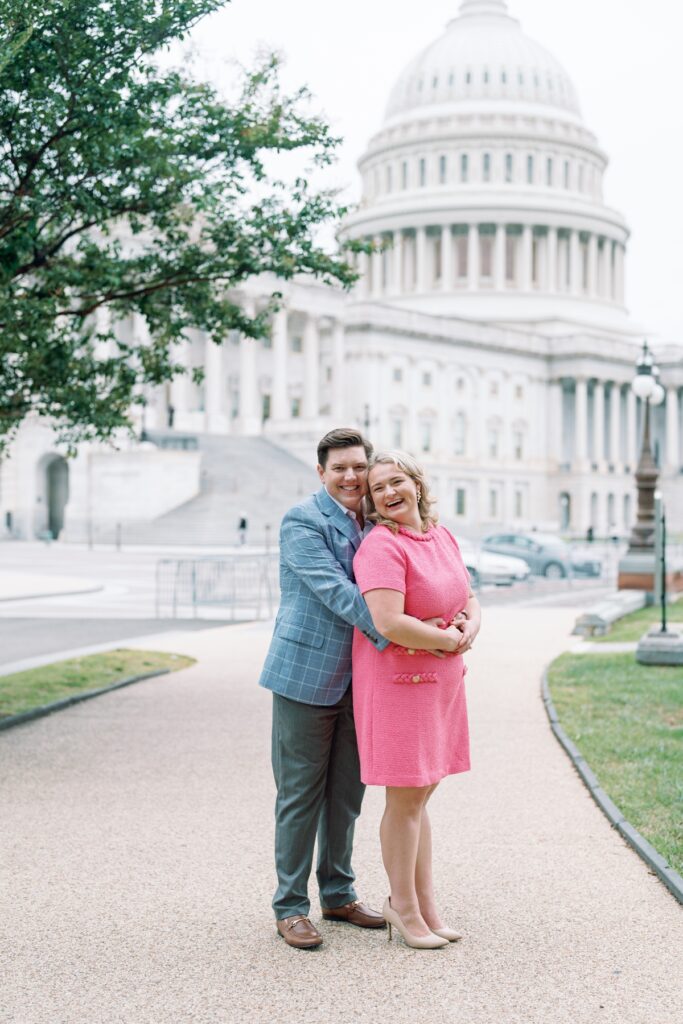 engaged Couple smiling at the camera in front of the capitol building in washington dc