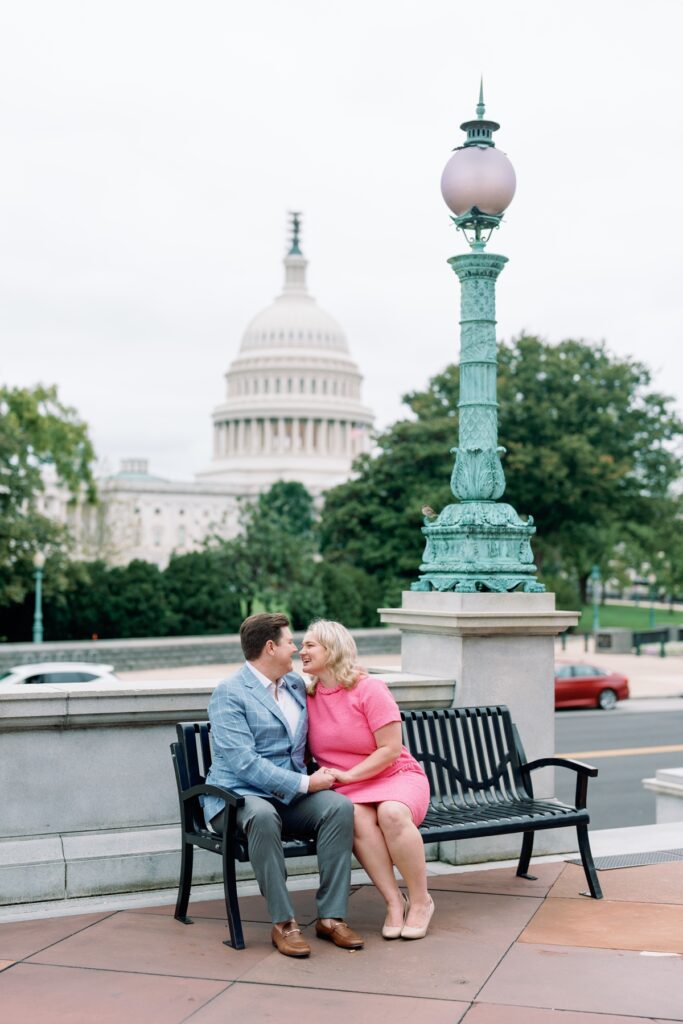 engaged Couple kissing with the capitol building in the background in washington dc