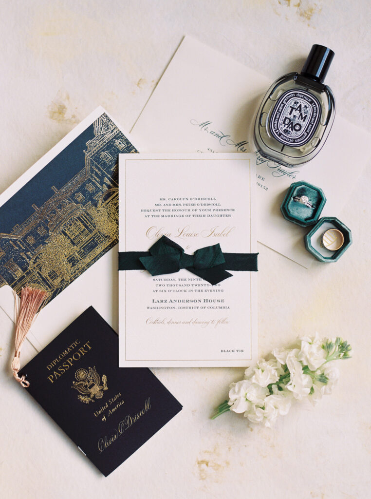 wedding invitation, wedding rings, and passport at larz anderson house in washington dc