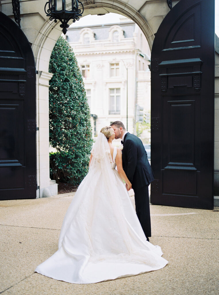 bride and groom kissing outside larz anderson house in washington dc