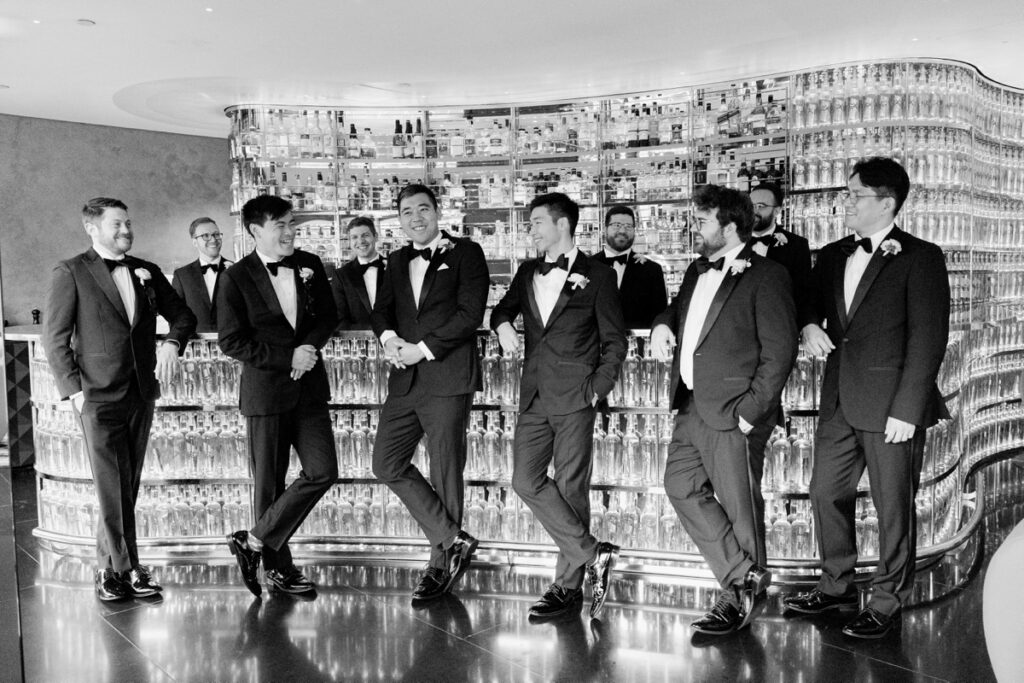 groomsmen hanging out at the bar at the watergate hotel in washington dc