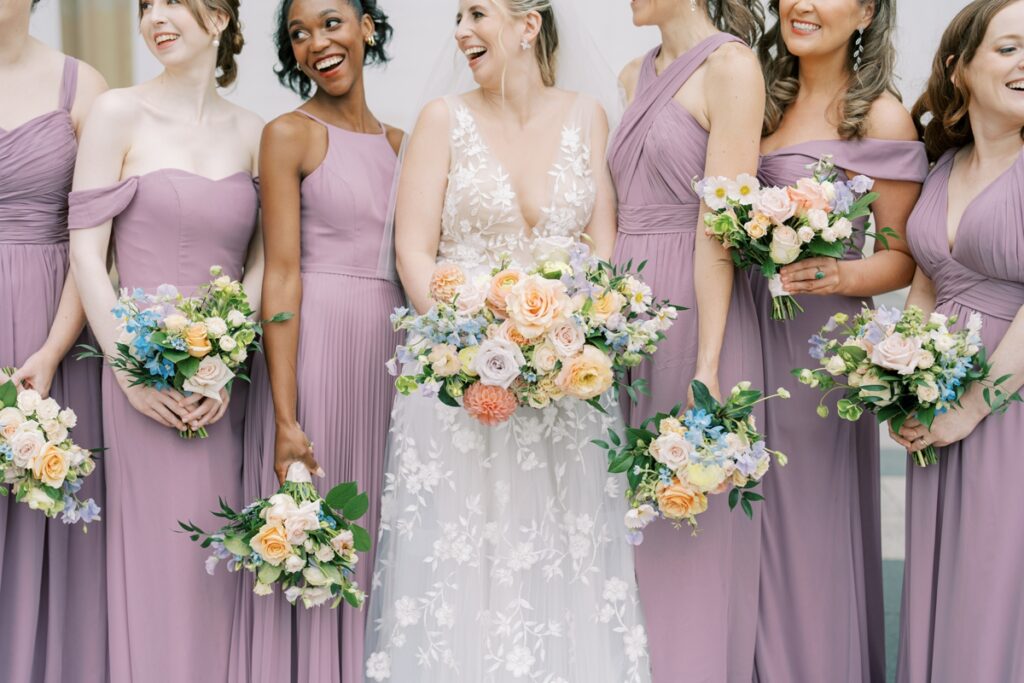 bride and bridesmaids laughing at the kennedy center in washington dc