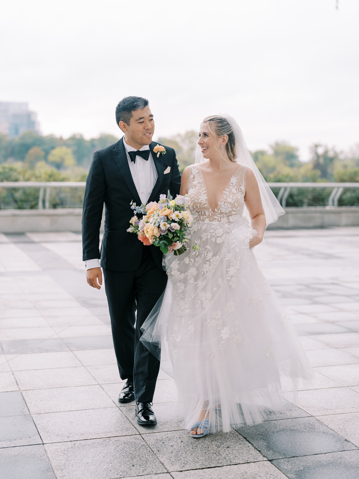 bride and groom walking at the kennedy center in washington dc