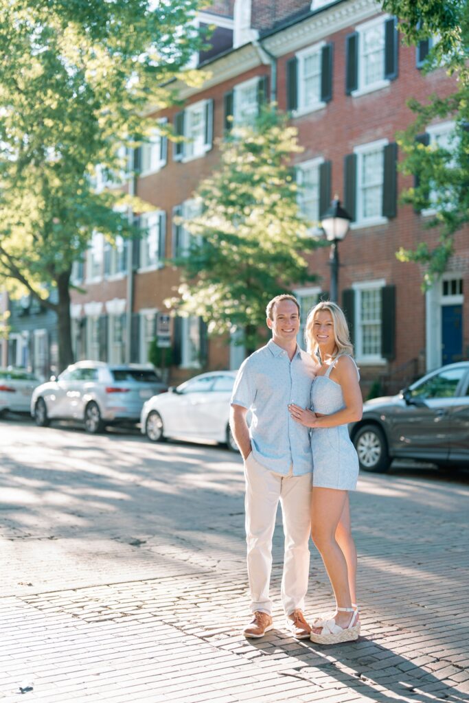 Couple smiling on a cobblestone street in old town alexandria