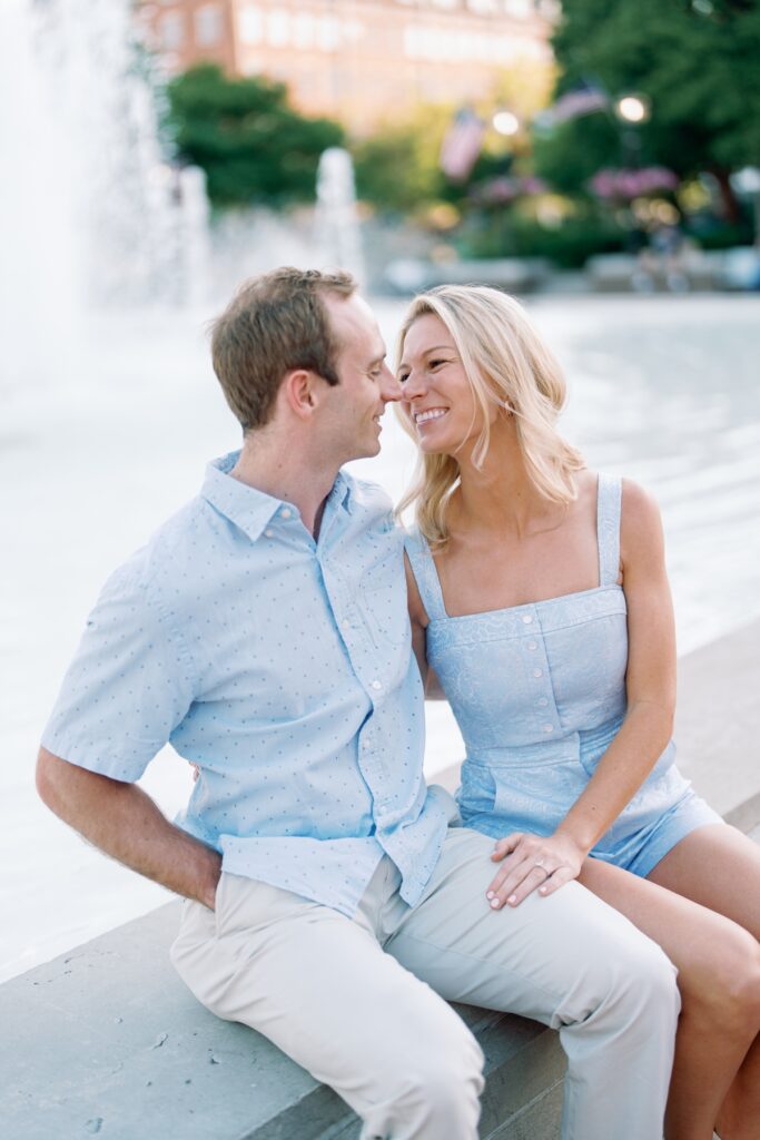 Couple smiling near a fountain in old town alexandria