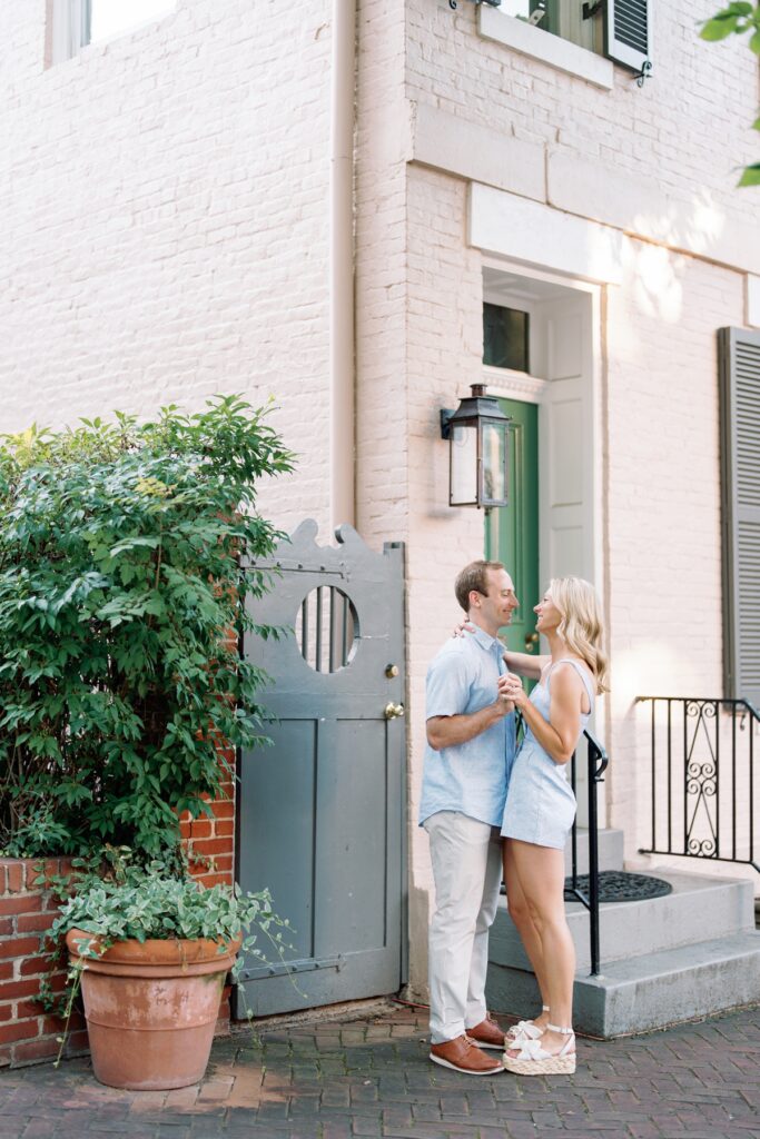 Couple smiling at each other in old town alexandria