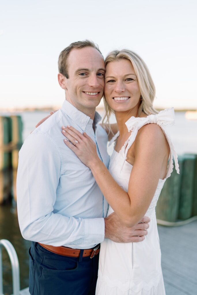 Couple smiling at each other in old town alexandria walking along the waterfront