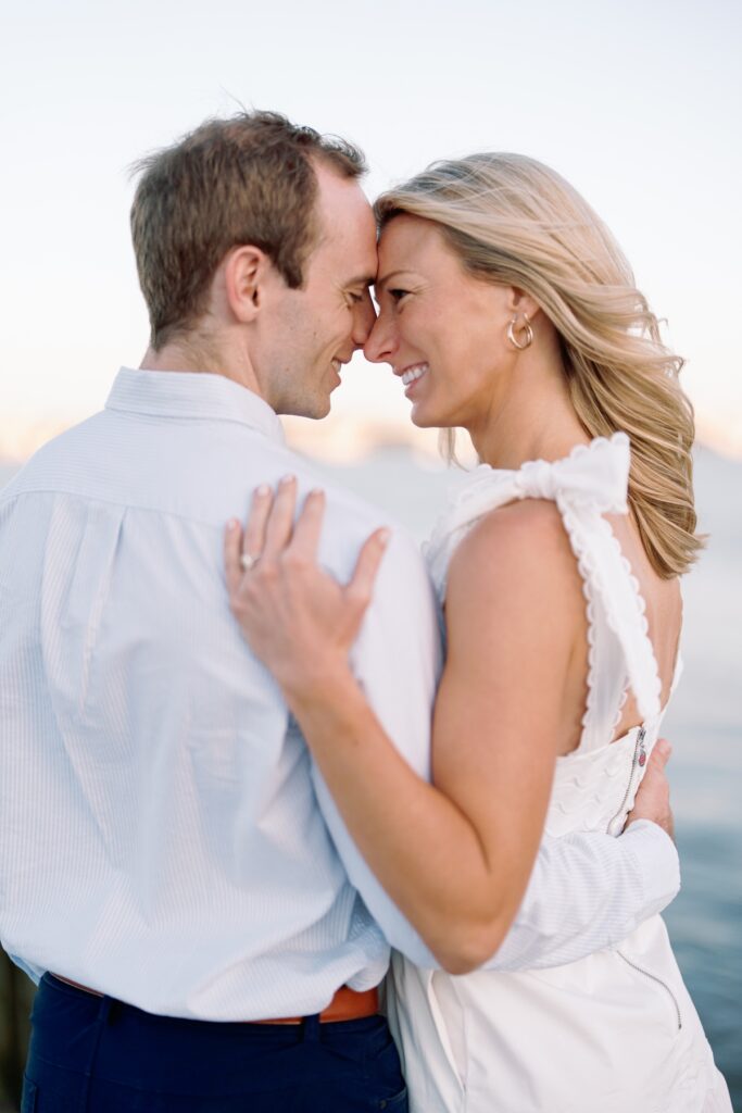 Couple smiling at each other in old town alexandria walking along the waterfront