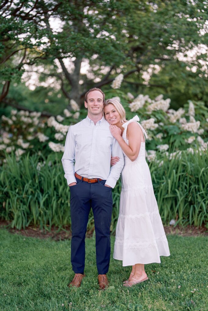 Couple smiling at the camera in old town alexandria walking along the waterfront