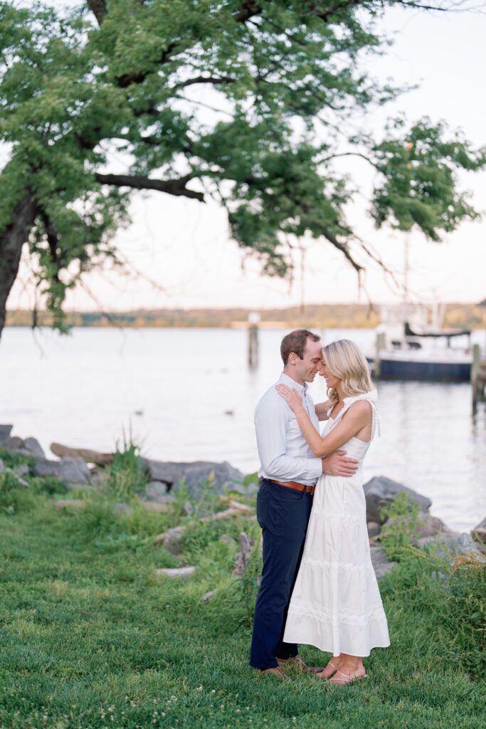 Couple smiling at each other in old town alexandria walking along the waterfront