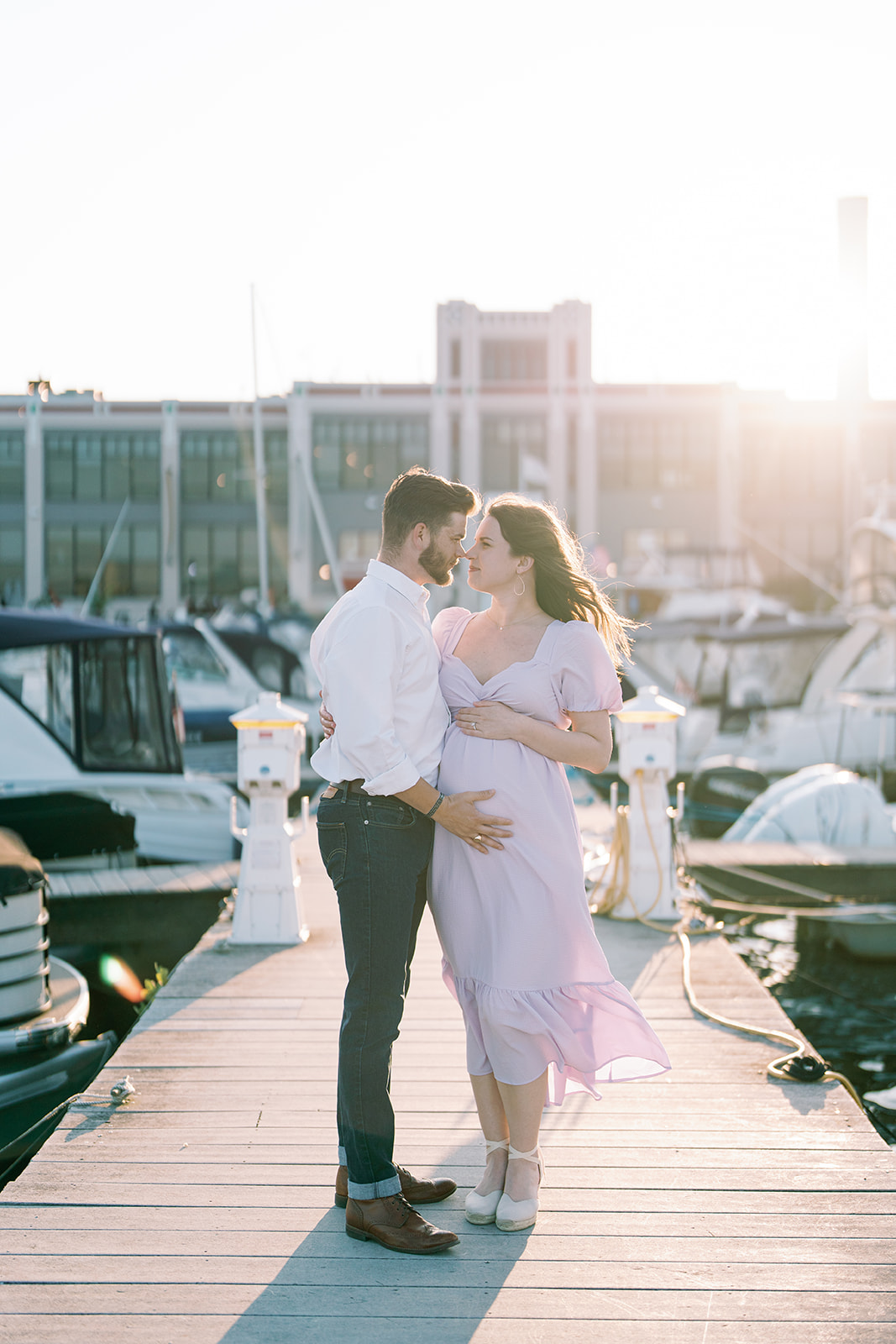 mom and dad maternity photos on pier in old town alexandria